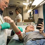 bloodworksnw-8771 Male Phlebotomist Helping a Female High School Student Give Blood
