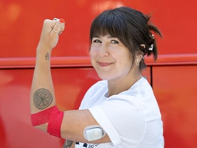 johnsonmadi_400x300-1 Woman Holding her Arm up After Donating Blood
