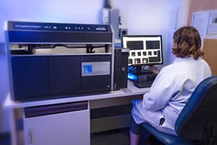 woman working on Amnis ImageStream X Mk II